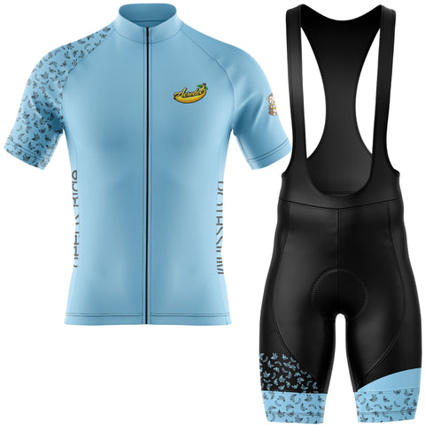 Light blue cycling jersey with short sleeves and black bib shorts on a white background