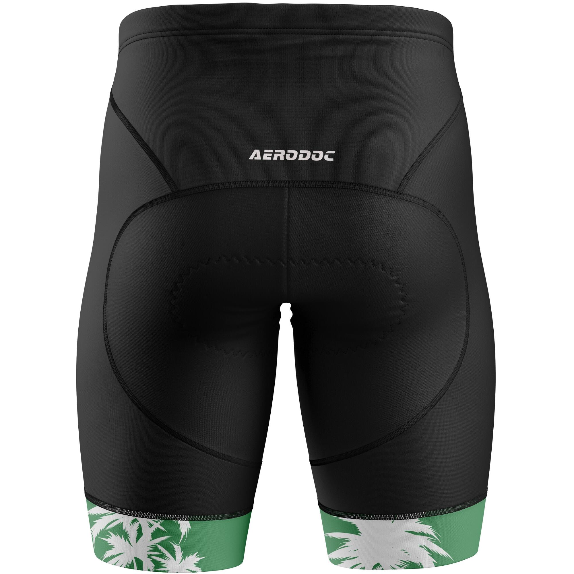 Black cycling shorts with green and white floral design at the bottom on a white background, featuring the brand 'Aerodoc'.