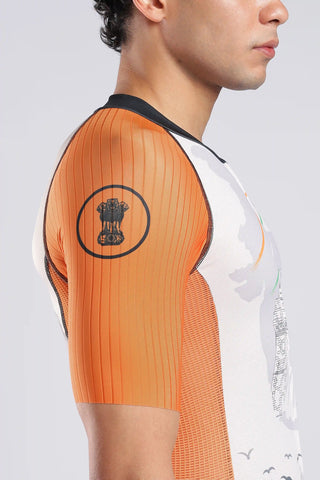 A male model wearing a AERODOC trisuit. The triauit features a white center with a faint map graphic, orange sleeves, and green patterned sides, with the Indian flag colors (saffron, white, and green) running vertically.