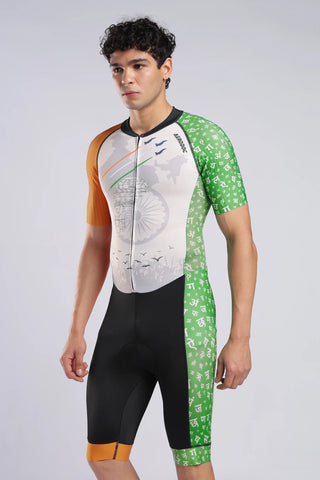 A male model wearing a short-sleeve cyclingrunning and swimmimg trisuit. The trisuit(onepiece) features a creamy front with a bicycle graphic, orange shoulder panels, and green patterned sleeves and side panels.
