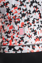 Aerodoc glitch Close-up of a cycling jersey with a black, white, and bright orange pixelated camouflage pattern.