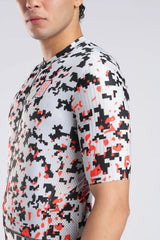 Aerodoc cycliung jersey a close-up side view of a man wearing a short-sleeve cycling jersey with a pixelated digital camouflage pattern in black, red, and white.