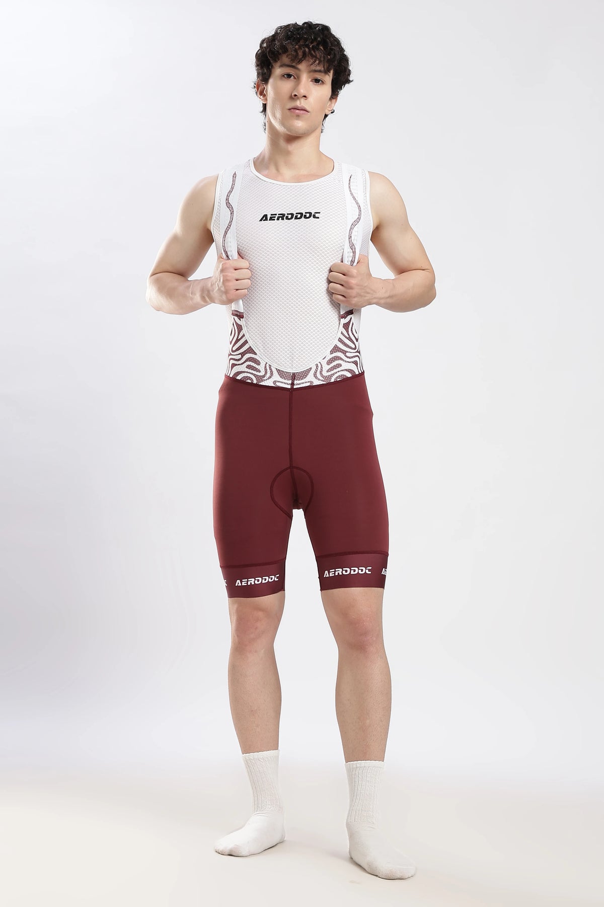 Model wearing Nitro Crimson Wine gel padded cycling bib shorts front view
