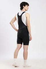 Full back view of black cycling bib shorts with mesh straps for ventilation