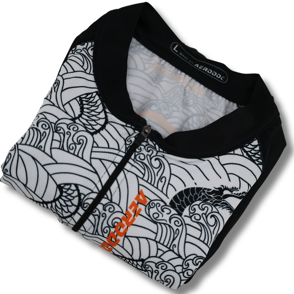 Black and orange cycling suit with a pattern on a white background